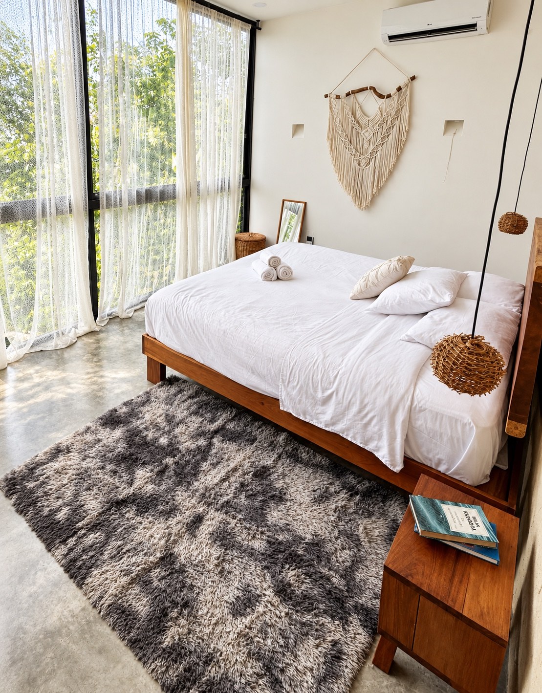 King bedroom with natural textures and jungle-facing windows